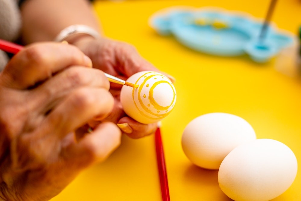 A person painting easter eggs